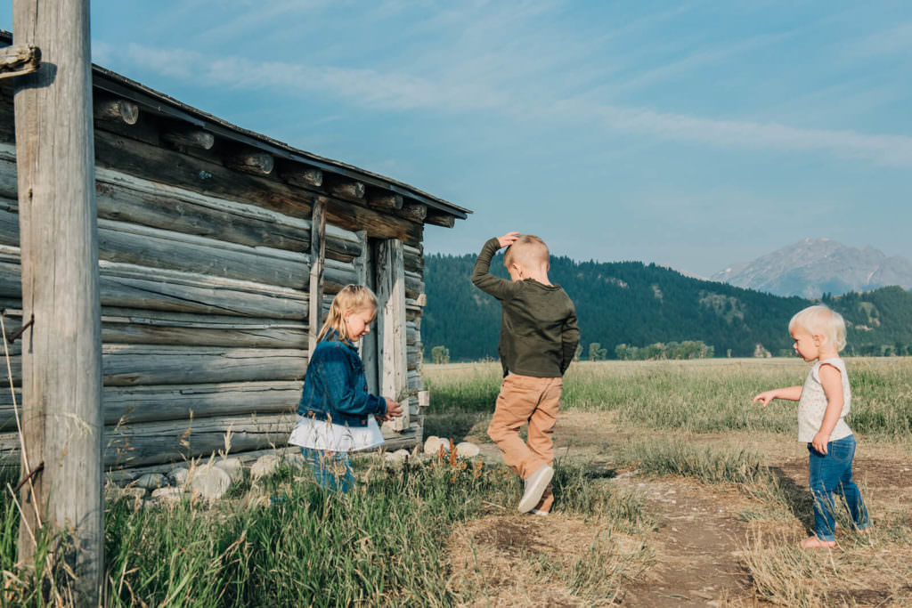 Kids playing by cabin in Mormon Row
