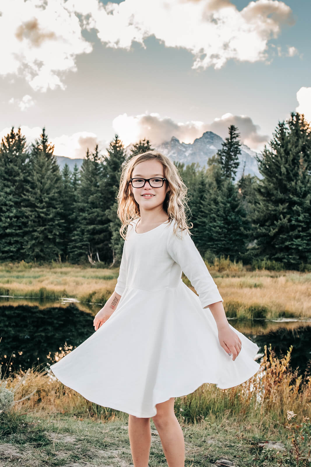 girl spinning in forest