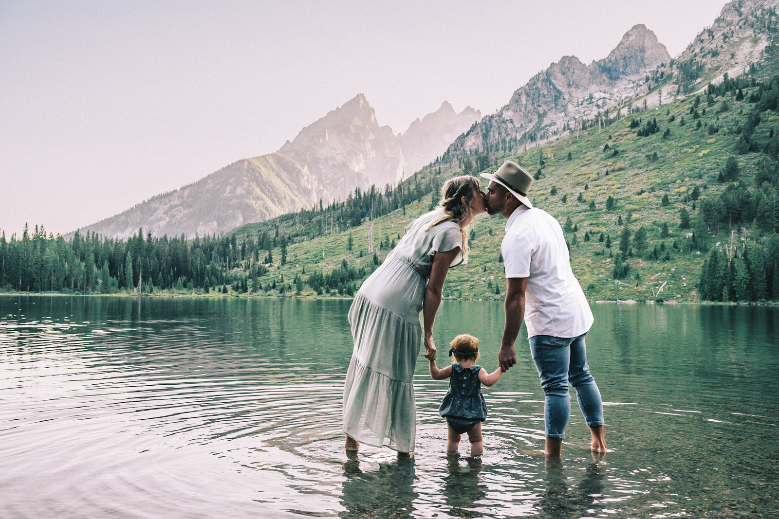candid family portrait at lake in the mountains