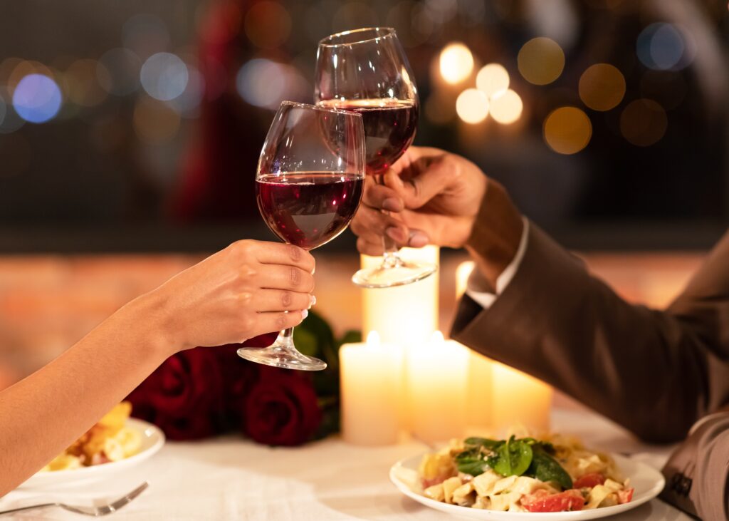 Romantic Restaurants in Jackson Hole, couple cheers with wine glasses, date night