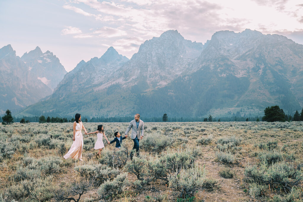 family holding hands walking in Grand Teton National Park, tips for family photos