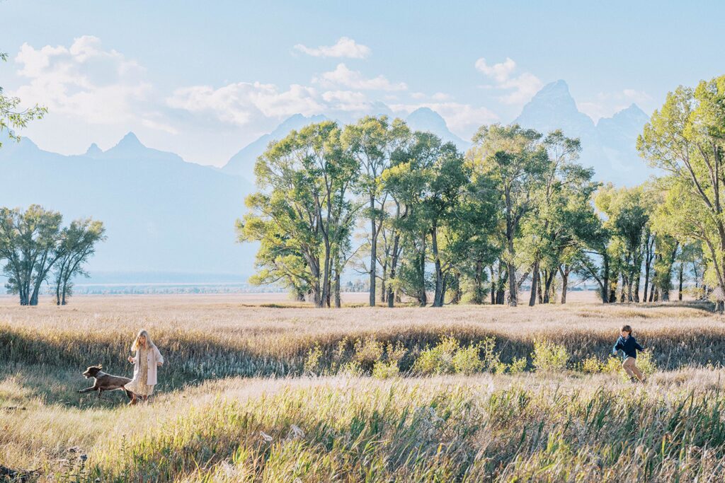 children running with dog in Grand Teton National Park, family portraits in Jackson Hole, 