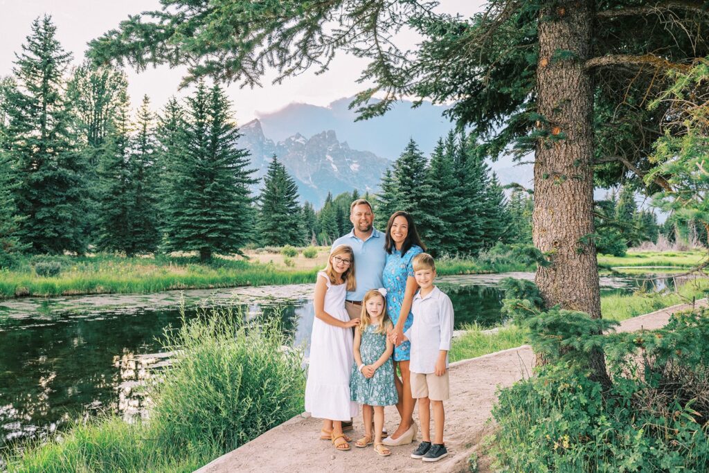 Family photo taken near the Grand Tetons in the summertime, best time to visit Jackson Hole